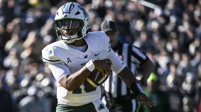 Tulane Green Wave quarterback Darian Mensah (10) scores a touchdown during the first half against the Navy Midshipmen at Navy-Marine Corps Memorial Stadium. Mandatory Credit: Tommy Gilligan-Imagn Images