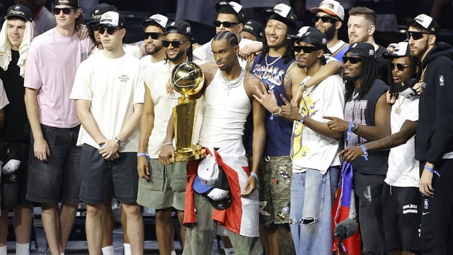 Thunder guard Shai Gilgeous-Alexander (2) holds the Larry OíBrien Championship Trophy with the team behind him during the Champions Opening Ceremony for the parade inside the Paycom Center