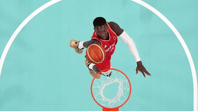 Aug 2, 2024; Villeneuve-d'Ascq, France; Germany point guard Dennis Schroder (17) shoots against France in the first half in a men’s group B basketball game during the Paris 2024 Olympic Summer Games at Stade Pierre-Mauroy. Mandatory Credit: John David Mercer-Imagn Images