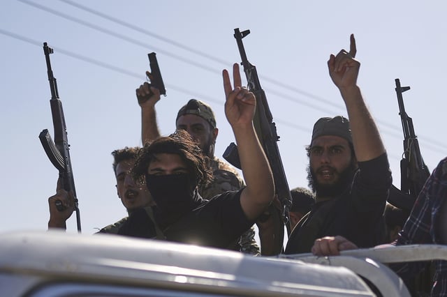 FILE - Bedouin fighters stand on a pickup truck as they arrive at al-Dour village on the outskirts of Sweida city, during clashes between the Bedouin clans and Druze militias, southern Syria, Friday, July 18, 2025. (AP Photo/Ghaith Alsayed, File)