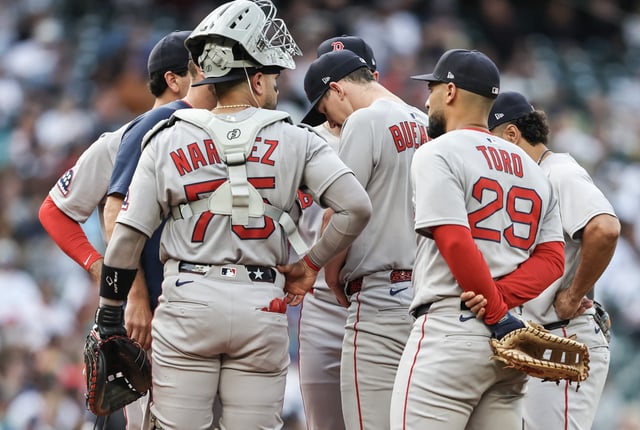 Walker Buehler #0 of the Boston Red Sox talks with his team against the Seattle Mariners at T-Mobile Park on June 17, 2025 in Seattle, Washington.