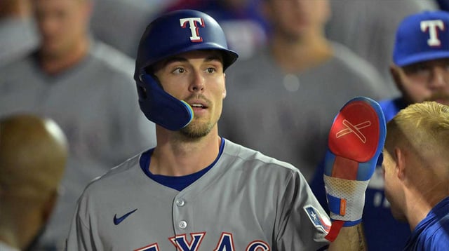 Jul 28, 2025; Anaheim, California, USA; Texas Rangers center fielder Evan Carter (32) in the dugout after scoring a run in the eighth inning against the Los Angeles Angels at Angel Stadium. Mandatory Credit: Jayne Kamin-Oncea-Imagn Images