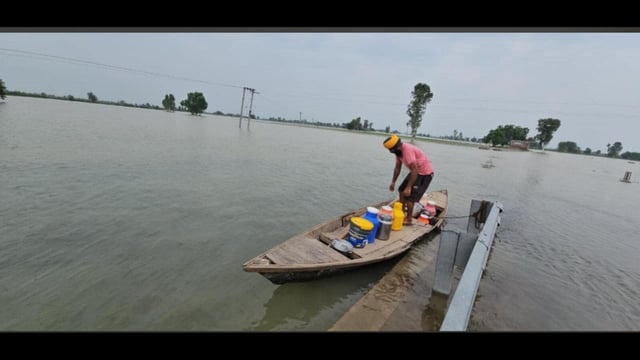 A man carries essentials in a boat on Thursday. (HT)