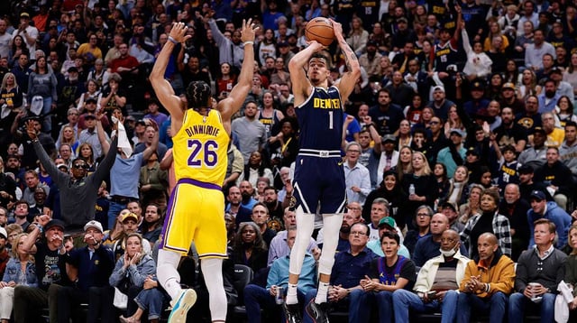 Apr 29, 2024; Denver, Colorado, USA; Denver Nuggets forward Michael Porter Jr. (1) attempts a shot as Los Angeles Lakers guard Spencer Dinwiddie (26) defends in the third quarter during game five of the first round for the 2024 NBA playoffs at Ball Arena. Mandatory Credit: Isaiah J. Downing-Imagn Images