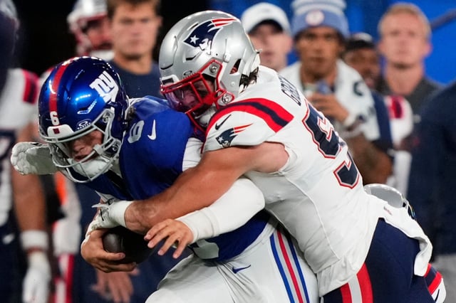 New York Giants quarterback Jaxson Dart (6) is tackled by New England Patriots linebacker Jack Gibbens (51) during the first quarter of an NFL football game, Thursday, Aug. 21, 2025, in East Rutherford, N.J. (AP Photo/Yuki Iwamura)