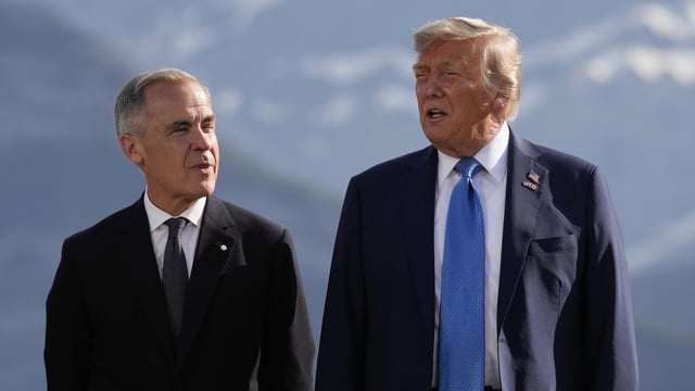Canada's Prime Minister Mark Carney, listens as President Donald Trump speaks during a group photo at the G7 Summit, Monday, June 16, 2025, in Kananaskis, Canada. (AP Photo/Mark Schiefelbein)