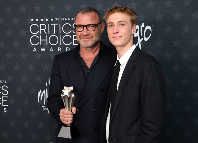 Liev Schreiber, left, poses with son Sasha Schreiber while holding the best supporting actor in a limited series award for "The Perfect Couple" at the 30th Critics' Choice Awards in Santa Monica, California, on Feb. 7, 2025.