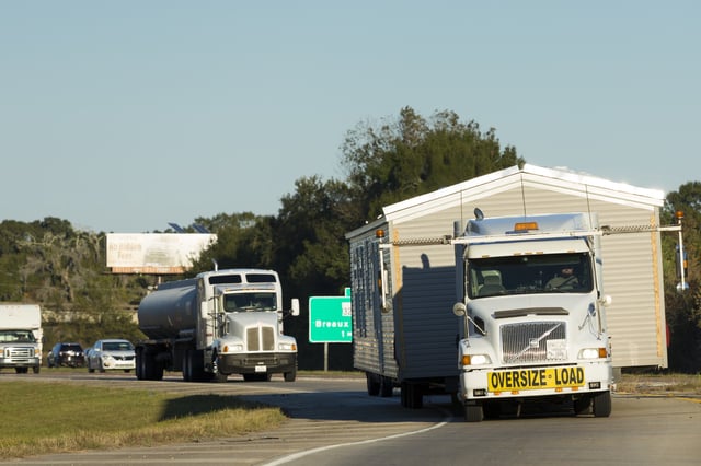 A commercial truck can be seen transporting a mobile home wide load on trucking route Interstate 10, Louisiana, USA (Photo by Tim Graham/Getty Images)