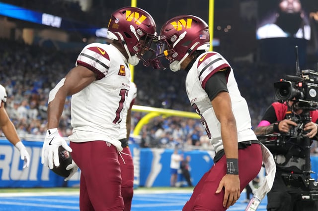 Terry McLaurin #17 of the Washington Commanders celebrates with Jayden Daniels #5 after catching a pass for a touchdown during the second quarter against the Detroit Lions in the NFC Divisional Playoff at Ford Field on January 18, 2025 in Detroit, Michigan.