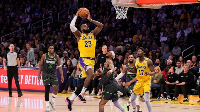 LeBron James (23) shoots as Minnesota Timberwolves guard Nickeil Alexander-Walker (9) defends 
