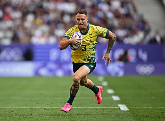 Paris 2024 Olympics - Rugby Sevens - Men's Pool B - Australia vs Kenya - Stade de France, Saint-Denis, France - July 24, 2024. Corey Toole of Australia scores their third try REUTERS/Dylan Martinez/File Photo