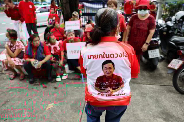 A portrait of Thailand's former Prime Minister Thaksin Shinawatra is printed on a T-shirt of a Pheu Thai supporter gathered to show support, on the day of a Thai criminal court's verdict in Shinawatra's lese majeste case, also known as a royal insult case, under Section 112 of Thailand's Criminal Code, stemming from a 2015 interview he gave while in South Korea during his long stint in self-imposed exile, in Bangkok, Thailand, August 22, 2025. REUTERS/Athit Perawongmetha