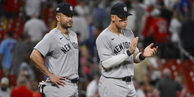 Aug 16, 2025; St. Louis, Missouri, USA; New York Yankees designated hitter Aaron Judge (99 and Giancarlo Stanton (27) celebrate after the Yankees defeated the St. Louis Cardinals at Busch Stadium. Mandatory Credit: Jeff Curry-Imagn Images.