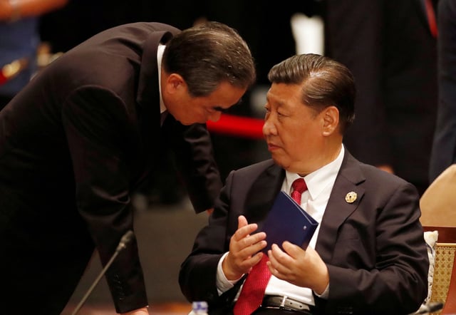 China's President Xi Jinping speaks to Foreign Minister Wang Yi during the APEC-ASEAN dialogue, on the sidelines of the APEC summit, in Danang, Vietnam November 10, 2017. REUTERS/Jorge Silva/File Photo