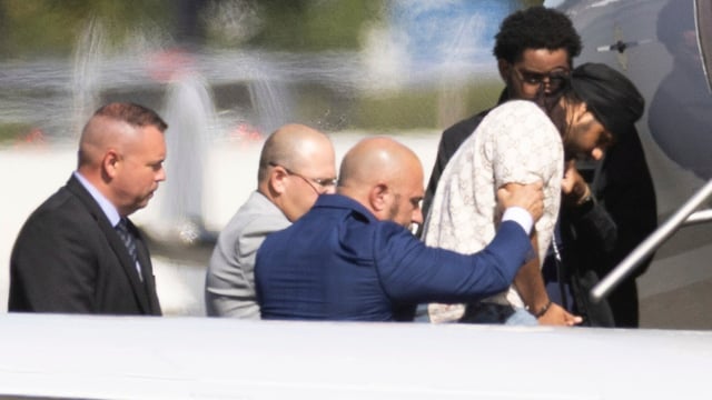 Harjinder Singh is escorted onto an airplane by Florida Lt. Gov. Jay Collins and law enforcement on Thursday in Stockton.