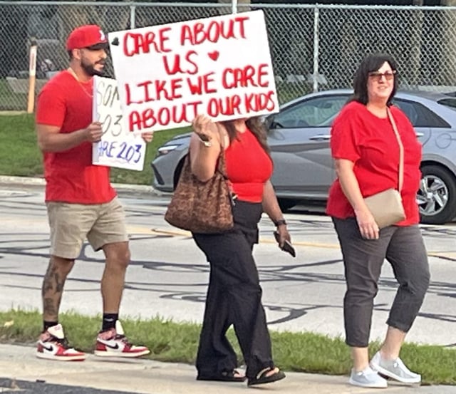 Members of the Naperville Unit Education Association, the District 203 teachers union, chanted "Red for Ed" as they marched Aug. 4 from Naperville Central High School to the district administration center.