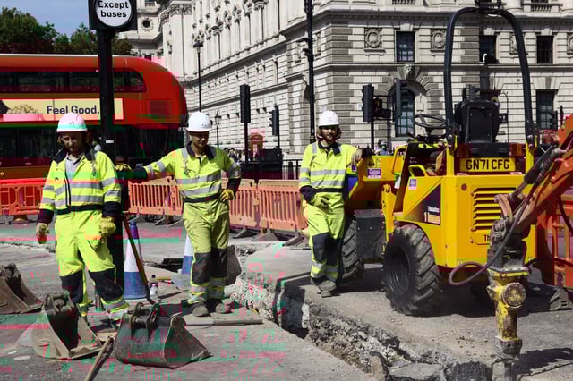 Workmen pause as they dig up a section of road in Westminster during a heatwave, in London, Britain, August 12, 2025. REUTERS/Jack Taylor/File Photo