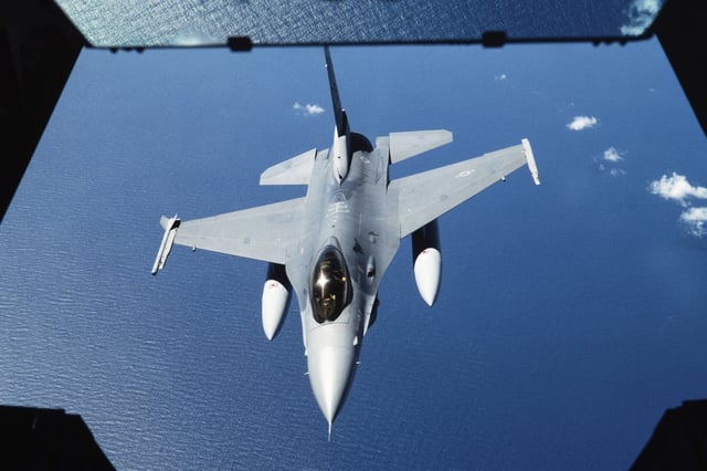 A U.S. Air Force F-16 fighter lines up for aerial refueling by a KC-10 Extender aerial tanker over the Pacific Ocean.