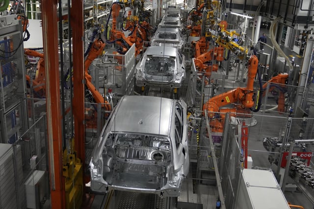 FILE - Robots work on cars of German car manufacturer BMW at an assembly line in Munich, Germany, Oct. 22, 2021. (AP Photo/Matthias Schrader, File)