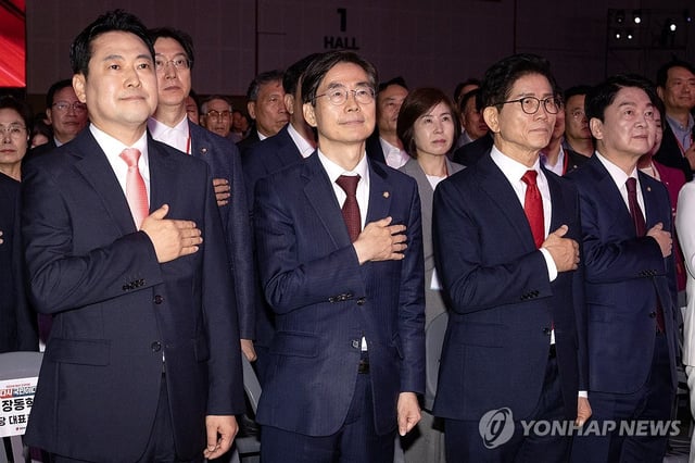 The four candidates for the main opposition People Power Party's leadership race -- (from L to R) Rep. Jang Dong-hyeok, Rep. Cho Kyoung-tae, former Labor Minister Kim Moon-soo and Rep. Ahn Cheol-soo -- salute the national flag at the party's national convention in the city of Cheongju, North Chungcheong Province, on Aug. 22, 2025. (Pool photo) (Yonhap)
