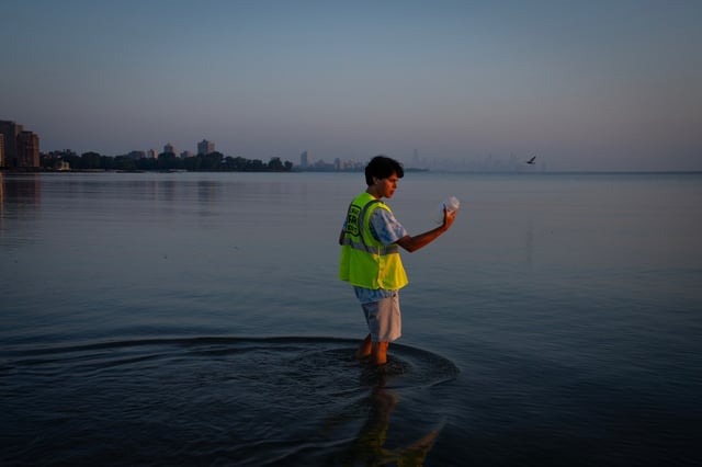 UIC student Andre Mejía collects water samples on Aug. 8, 2025, at Rainbow Beach as part of a collaboration between UIC and the Chicago Park District to have water tested. The results allow the Park District to relay the most up-to-date water quality conditions on its website and through a color-coded flag system. (E. Jason Wambsgans/Chicago Tribune)
