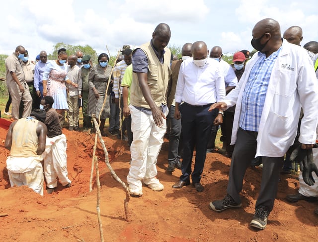 FILE - Former Kenya Interior Minister Kithure Kindiki, center, in a white shirt, inspects graves where victims of a Christian cult are buried in the Shakahola forest, near the tourist town of Malindi, Kenya, Tuesday, April 25, 2023. (AP Photo/File)