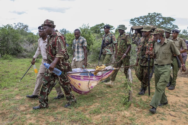 FILE - Police and local residents load the exhumed bodies of victims of a religious cult into the back of a truck in the village of Shakahola, near the coastal city of Malindi, in southern Kenya, Sunday, April 23, 2023. (AP Photo/File)
