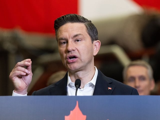 Conservative leader Pierre Poilievre, flanked by members of parliament, speaks in front of workers and a fracking pump at EnQuest Energy Solutions in Calgary on Thursday, August 7, 2025.