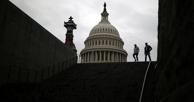 Pedestrians walk along the East Front of the U.S. Capitol Building on Capitol Hill in Washington on Dec. 4, 2020.