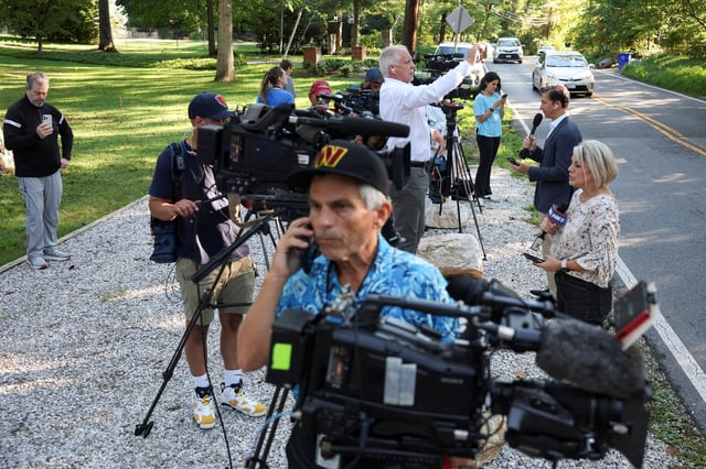 Members of the media stand outside the home of the former White House national security adviser John Bolton as it is searched by FBI members, in Bethesda, Maryland, U.S., August 22, 2025. REUTERS/Tasos Katopodis