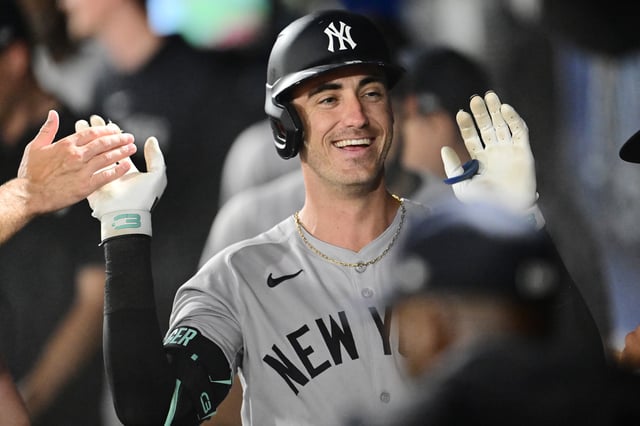 TAMPA, FLORIDA - AUGUST 19: Cody Bellinger #35 of the New York Yankees celebrates with teammates in the dugout after hitting a home run in the first inning against the Tampa Bay Rays at George M. Steinbrenner Field on August 19, 2025 in Tampa, Florida.