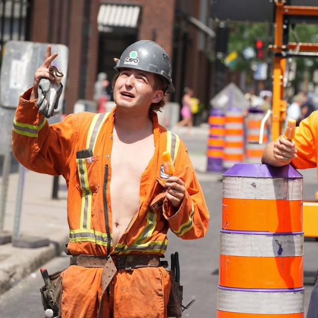 Construction workers eat popsicles to keep cool on their worksite in downtown Montreal on Tuesday, June 18, 2024. Environment Canada issued a heat warning Tuesday for the remainder of the week, expecting temperatures of 30-35 degrees Celsius, but feeling closer to 40-45 degrees with the humidex. THE CANADIAN PRESS/Christinne Muschi