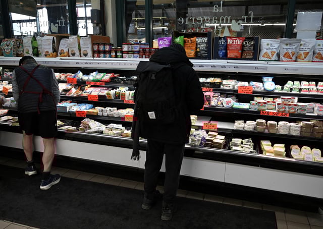 People shop for cheese at a cheese shop at Atwater Market in Montreal, Quebec, Canada March 9, 2025. REUTERS/Graham Hughes/File Photo