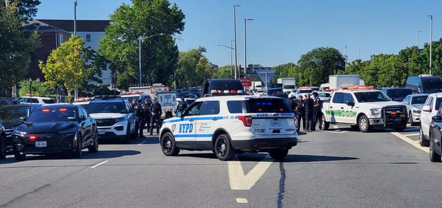 An NYPD officer was rushed to the hospital in a police cruiser after he was shot in the leg and arm on 22nd Rd. near the Whitestone Expressway Service Rd. in Whitestone, Queens, on Friday, Aug. 22, 2025. (Theodore Parisienne / New York Daily News)