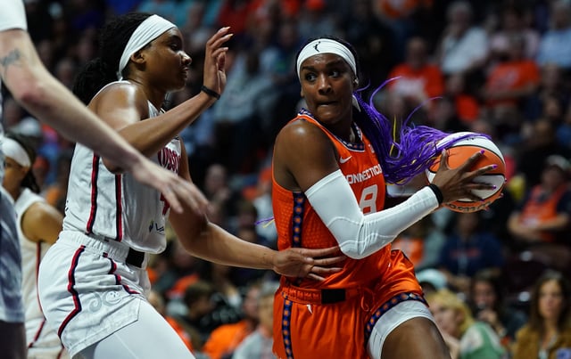 Aug 21, 2025; Uncasville, Connecticut, USA; Connecticut Sun forward Aaliyah Edwards (8) drives the ball against Washington Mystics forward Kiki Iriafen (44) in the second half at Mohegan Sun Arena. Mandatory Credit: David Butler II-Imagn Images