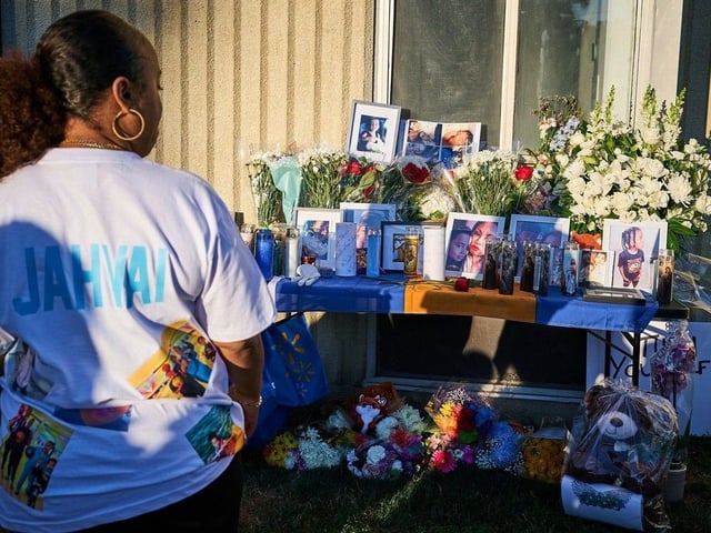 Community members stop at a vigil in Toronto, on Thursday, Aug. 21, 2025. Jahvai Roy, 8, was struck and killed by a stray bullet over the weekend.