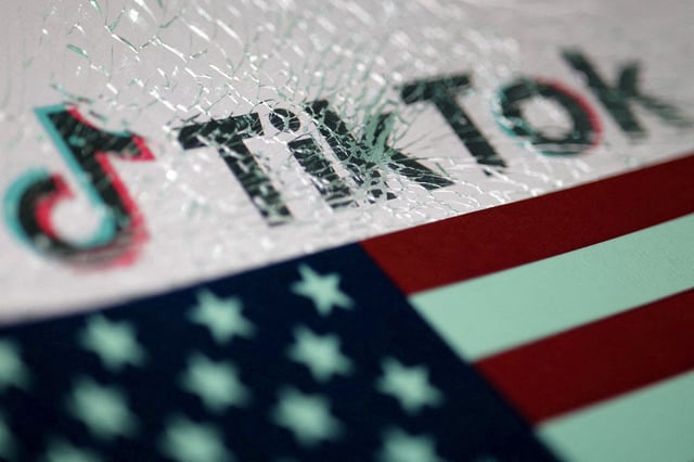 The U.S. flag and the TikTok logo seen through broken glass are seen in this illustration taken January 16, 2025. REUTERS/Dado Ruvic/Illustration/File Photo