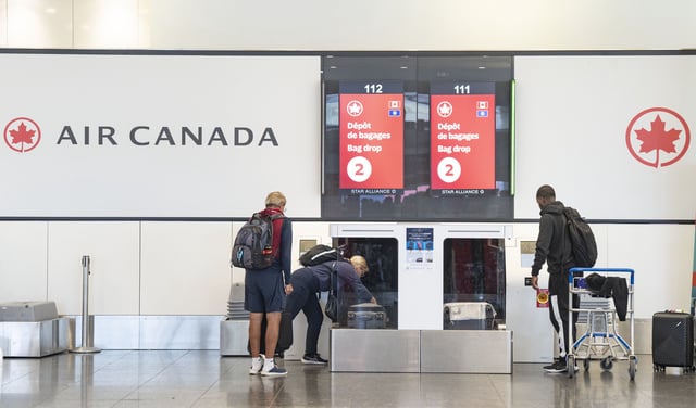 Air Canada travellers load their luggage at Montreal-Pierre Elliott Trudeau International Airport in Dorval, Que., on Tuesday,  Aug. 19, 2025. THE CANADIAN PRESS/Christinne Muschi