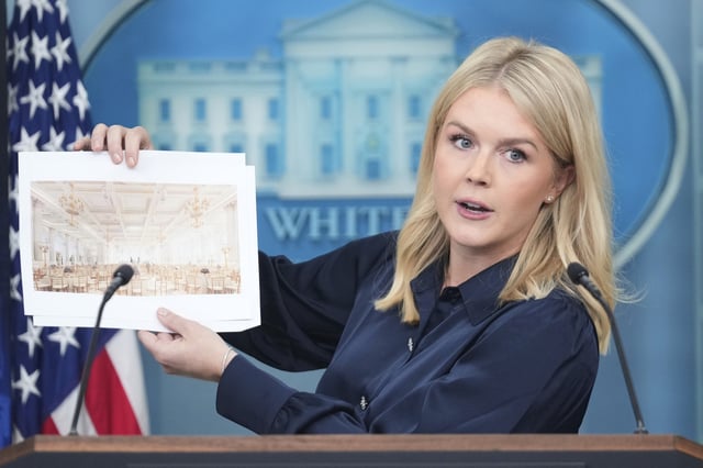 White House press secretary Karoline Leavitt holds up photos of the planned new White House ballroom during a press briefing at the White House in Washington, Thursday, July 31, 2025.
