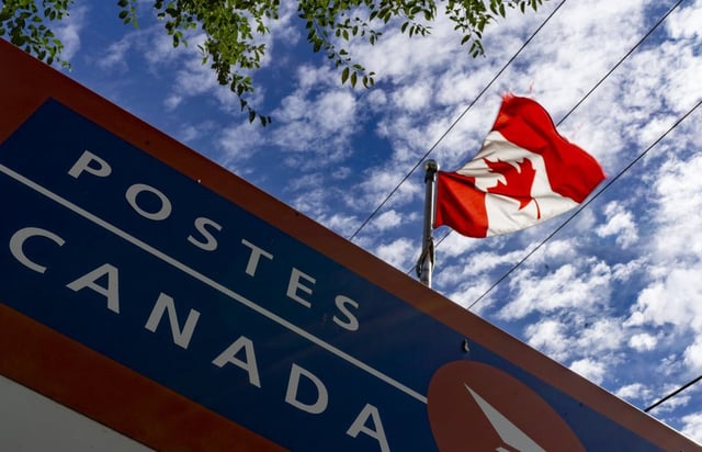 A Canada Post sign is seen in Montreal on Tuesday, Aug. 19, 2025. THE CANADIAN PRESS/Christinne Muschi