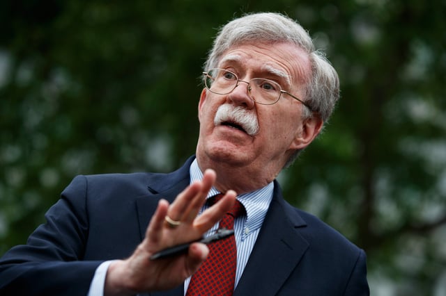 FILE - National security adviser John Bolton talks to reporters about Venezuela, outside the White House, May 1, 2019, in Washington. (AP Photo/Evan Vucci File)