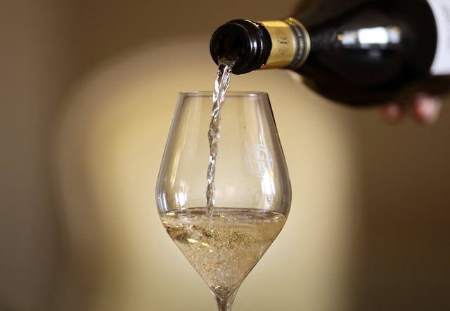 A glass of Champagne is poured at Leclerc Briant Champagne house, in Epernay, France, August 22, 2025. REUTERS/Christian Hartmann
