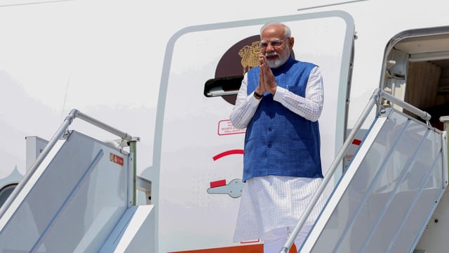Prime Minister Narendra Modi gestures as he steps off the plane in Zagreb, Croatia, on June 18, 2025.