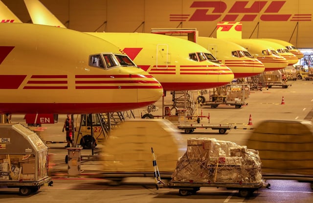 29.08.2018 Saxony, Schkeuditz: DHL cargo aircraft are unloaded at Leipzig/Halle Airport at night. The DHL hub at Leipzig Airport went into operation ten years ago. At that time, 125,000 shipments were handled per day on average, today it is 350,000. the Leipzig hub has developed into the largest within the DHL Express network over the ten years. Meanwhile 5700 people work at the location, 99 percent of them from the region. In addition to five new aircraft, DHL is planning a flight simulator centre for pilot training and training purposes.