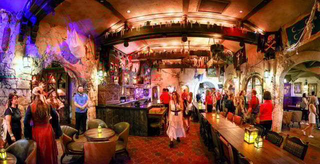 Guests preview The Beak and Barrel Tavern on Friday, at the Magic Kingdom in Walt Disney World. Opening Aug. 29, the Pirates of the Caribbean–themed venue features the park’s first dedicated bar for cocktails, beer and wine. (Joe Burbank/Orlando Sentinel)