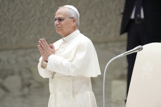Pope Leo XIV waves as he arrives for his weekly general audience, at The Vatican, Wednesday, Aug.20, 2025.