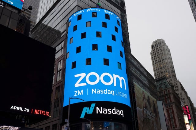 FILE – This April 18, 2019, file photo shows a sign for Zoom Video Communications ahead of the company’s Nasdaq IPO in New York.  The video-conferencing service is cutting about 1,300 jobs, or approximately 15% of its workforce. CEO Eric Yuan said in a blog post Tuesday, Feb. 7, 2023, that the company ramped up staffing during the COVID-19 pandemic, when businesses became increasingly reliant on its service as people worked from home. Yuan said Zoom grew three times in size within 24 months to manage demand. (AP Photo/Mark Lennihan, File)