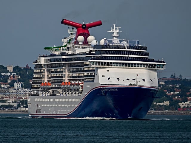 LISBON, PORTUGAL - JUNE 03: Carnival Miracle, a 88,500 GT Spirit-class cruise ship operated by Carnival Cruise Line, sails the Tagus River after departure from the cruise terminal on June 03, 2025, in Lisbon, Portugal. Tourism in Portugal reached record figures in 2024, exceeding 27 billion euros in revenue, an increase of 8.8% compared to 2023. (Photo by Horacio Villalobos#Corbis/Corbis via Getty Images)