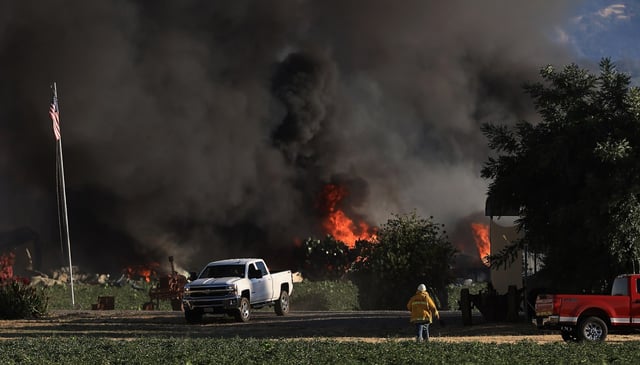 A fireworks distribution center in https://www.mercurynews.com/2025/07/08/search-warrant-served-on-sf-house-in-connection-with-fireworks-blast/the Yolo County community of Esparto, burns, shortly before exploding, Tuesday, July 1, 2025.  (Kent Porter / The Press Democrat)