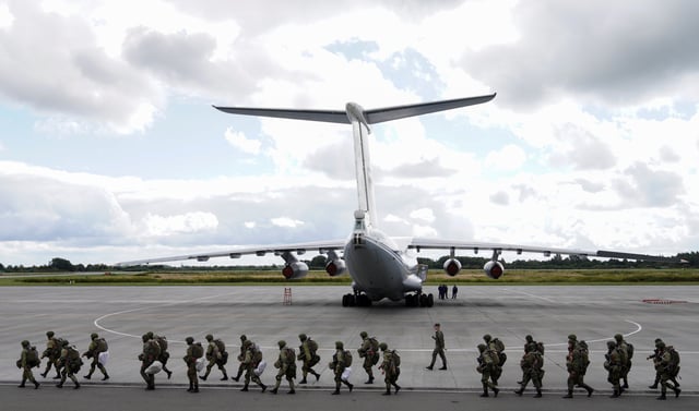 Russian paratroopers walk before boarding Ilyushin Il-76 transport planes as they take part in the military exercises "Zapad-2021" staged by the armed forces of Russia and Belarus at an aerodrome in Kaliningrad Region, Russia, September 13, 2021. REUTERS/Vitaly Nevar/File Photo